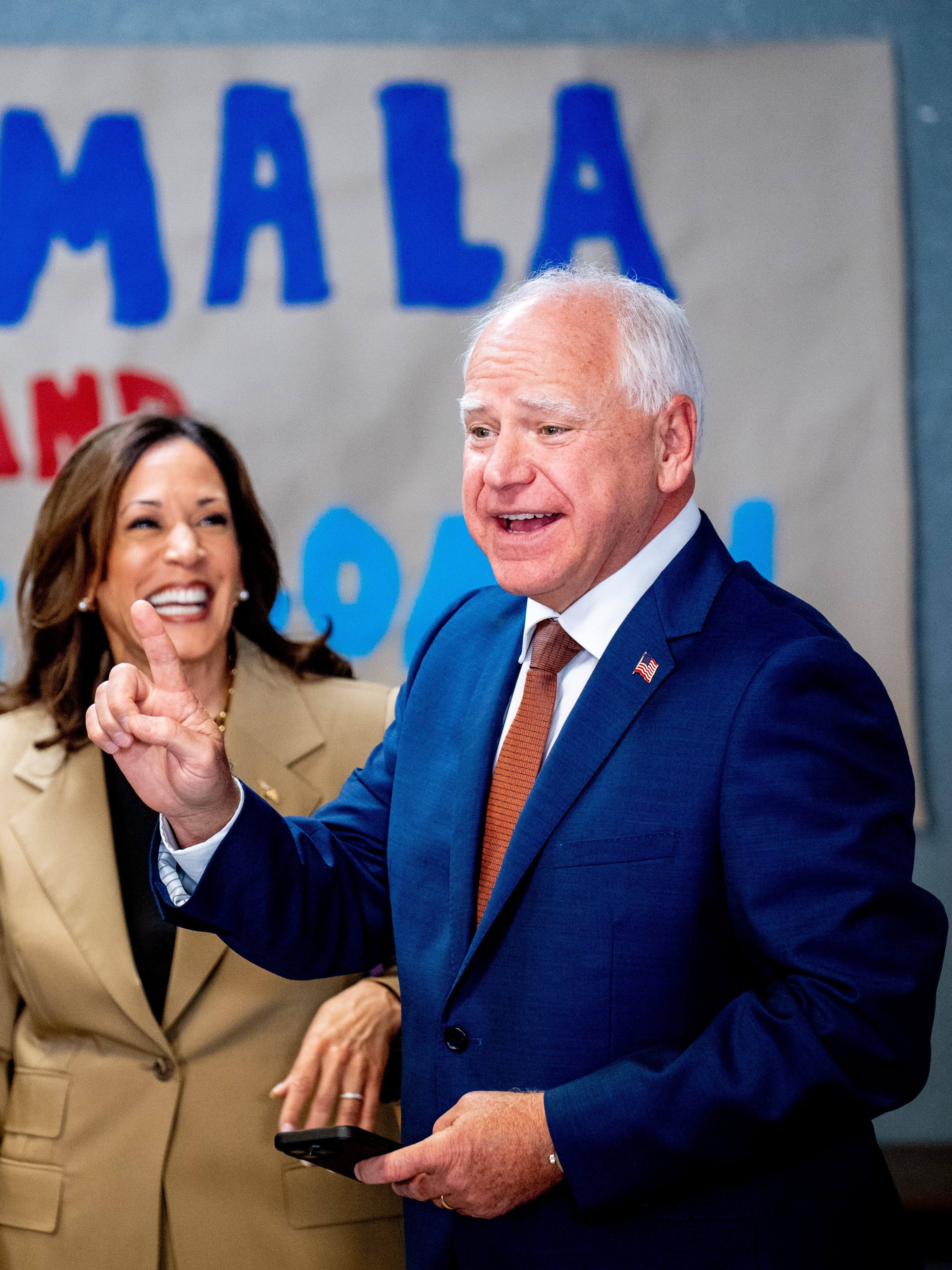GLENDALE, ARIZONA - AUGUST 9: Democratic vice presidential candidate Minnesota Governor Tim Walz asks Democratic presidential candidate, U.S. Vice President Kamala Harris for a selfie in front of a sign that reads "Kamala and The Coach" during stop at a campaign office on August 9, 2024 in Glendale, Arizona. Kamala Harris and her newly selected running mate Tim Walz are campaigning across the country this week. (Photo by Andrew Harnik/Getty Images)