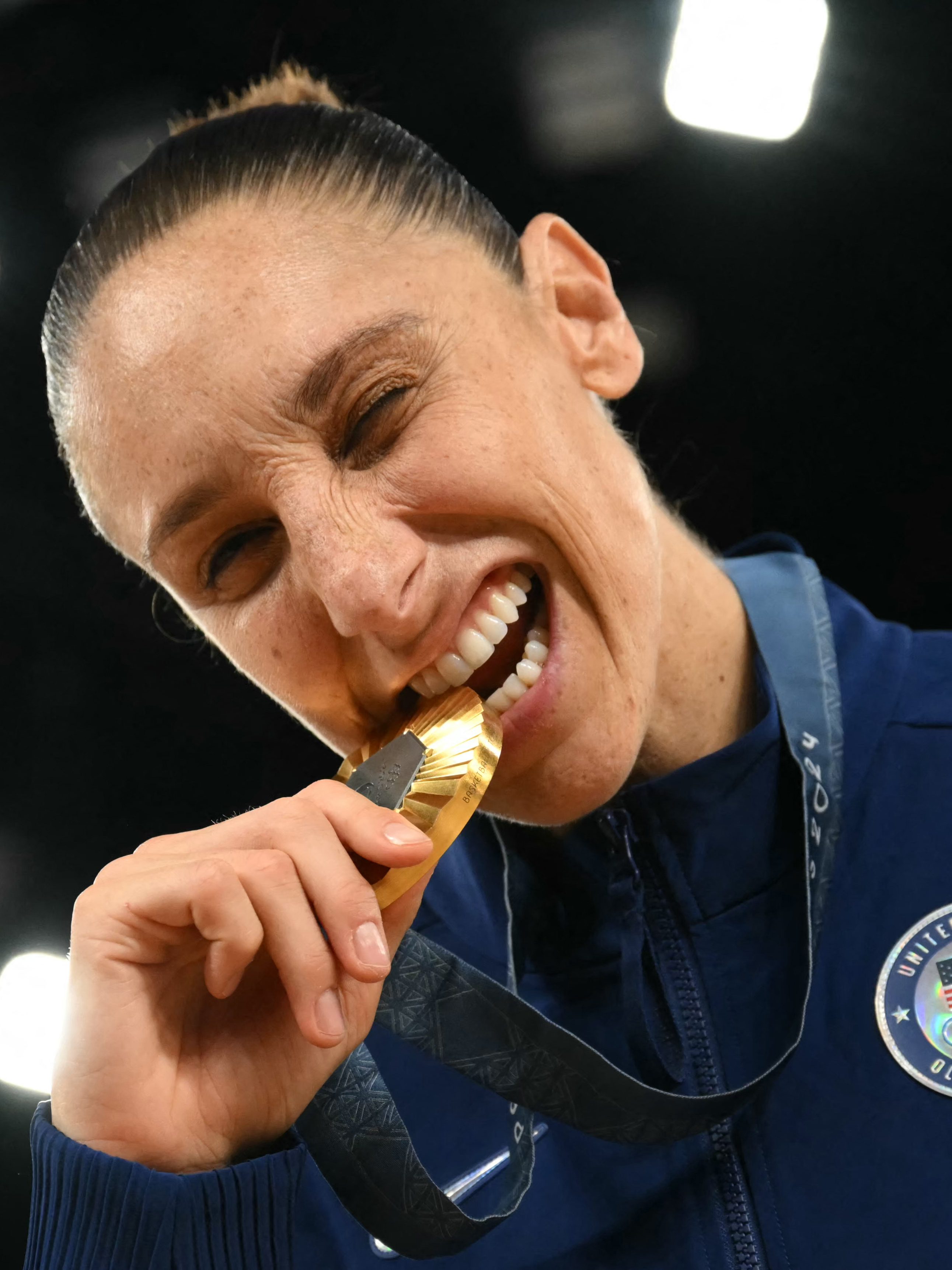 Gold medallists USA's #12 Diana Taurasi poses with her medal after the women's Gold Medal basketball match between France and the USA during the Paris 2024 Olympic Games at the Bercy  Arena in Paris on August 11, 2024. (Photo by Paul ELLIS / AFP) (Photo by PAUL ELLIS/AFP via Getty Images)