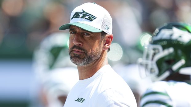 EAST RUTHERFORD, NEW JERSEY - AUGUST 10: Aaron Rodgers #8 of the New York Jets looks on against the Washington Commanders during the preseason game at MetLife Stadium on August 10, 2024 in East Rutherford, New Jersey. The Jets defeated the Commanders 20-17. (Photo by Mitchell Leff/Getty Images)