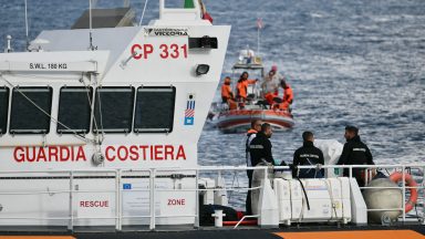 Italian Coast Guards carry a body on a rescue boat in Porticello harbor near Palermo, with a third body at the back of the boat on August 21, 2024, two days after the British-flagged luxury yacht Bayesian sank. Divers searching for six missing people following the sinking of a superyacht off Sicily in a storm have found four bodies, a source close to the search told AFP. The Bayesian, which had 22 people aboard including 10 crew, was anchored some 700 metres from port before dawn when it was struck by a waterspout. Among the six missing were UK tech entrepreneur Mike Lynch and his 18-year-old daughter Hannah, and Jonathan Bloomer, the chair of Morgan Stanley International, and his wife Judy. (Photo by Alberto PIZZOLI / AFP) (Photo by ALBERTO PIZZOLI/AFP via Getty Images)