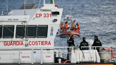 Italian Coast Guards carry a body on a rescue boat in Porticello harbor near Palermo, with a third body at the back of the boat on August 21, 2024, two days after the British-flagged luxury yacht Bayesian sank. Divers searching for six missing people following the sinking of a superyacht off Sicily in a storm have found four bodies, a source close to the search told AFP. The Bayesian, which had 22 people aboard including 10 crew, was anchored some 700 metres from port before dawn when it was struck by a waterspout. Among the six missing were UK tech entrepreneur Mike Lynch and his 18-year-old daughter Hannah, and Jonathan Bloomer, the chair of Morgan Stanley International, and his wife Judy. (Photo by Alberto PIZZOLI / AFP) (Photo by ALBERTO PIZZOLI/AFP via Getty Images)