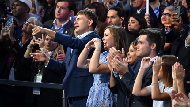 TOPSHOT - Minnesota Governor and 2024 Democratic vice presidential candidate Tim Walz's son Gus (L) and daughter Hope (2nd L) react as he speaks on the third day of the Democratic National Convention (DNC) at the United Center in Chicago, Illinois, on August 21, 2024. Vice President Kamala Harris will formally accept the party's nomination for president at the DNC which runs from August 19-22 in Chicago. (Photo by ANDREW CABALLERO-REYNOLDS / AFP) (Photo by ANDREW CABALLERO-REYNOLDS/AFP via Getty Images)