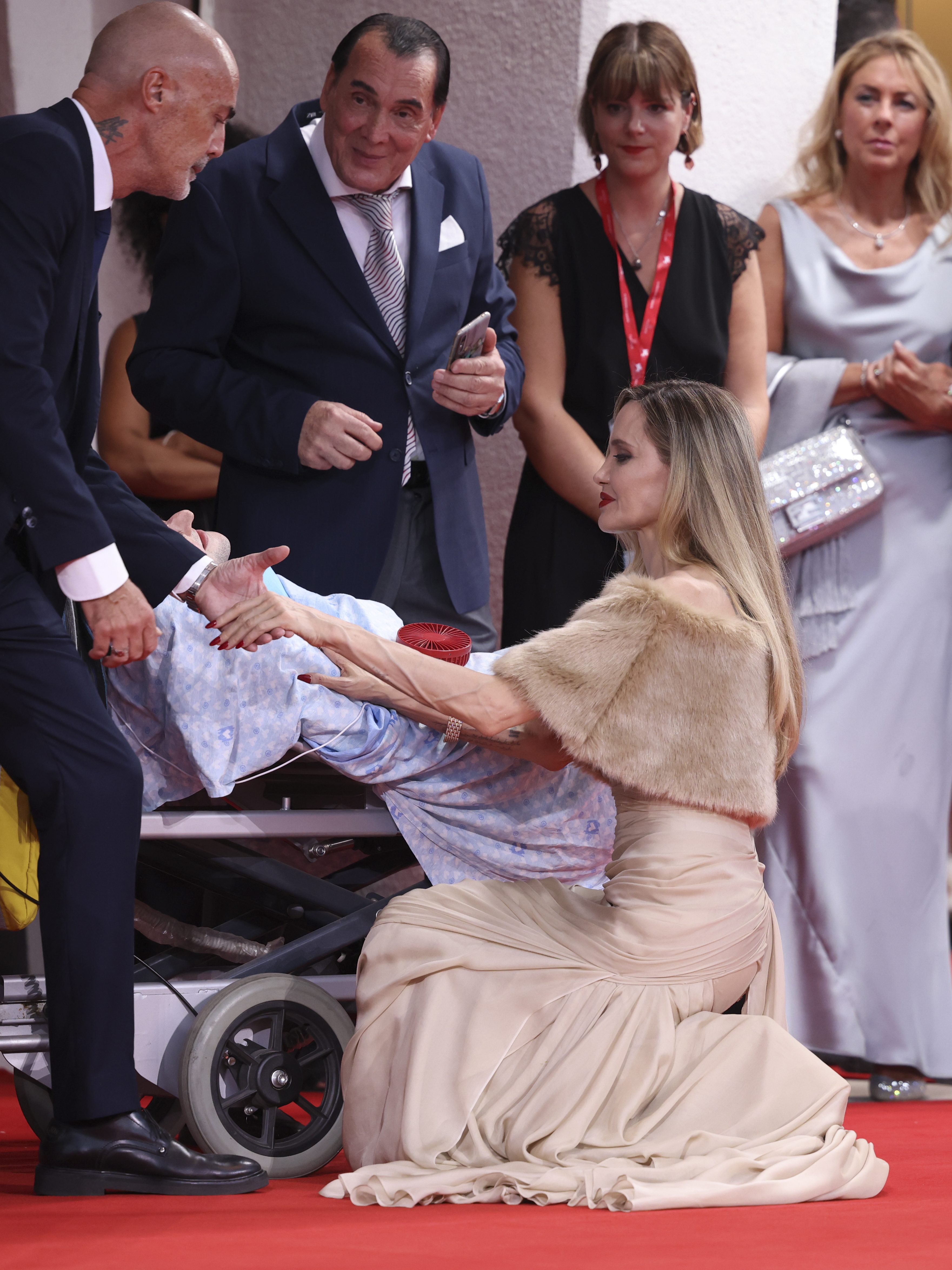 Angelina Jolie speaks to a disabled person on the red at red carpet for "Maria"