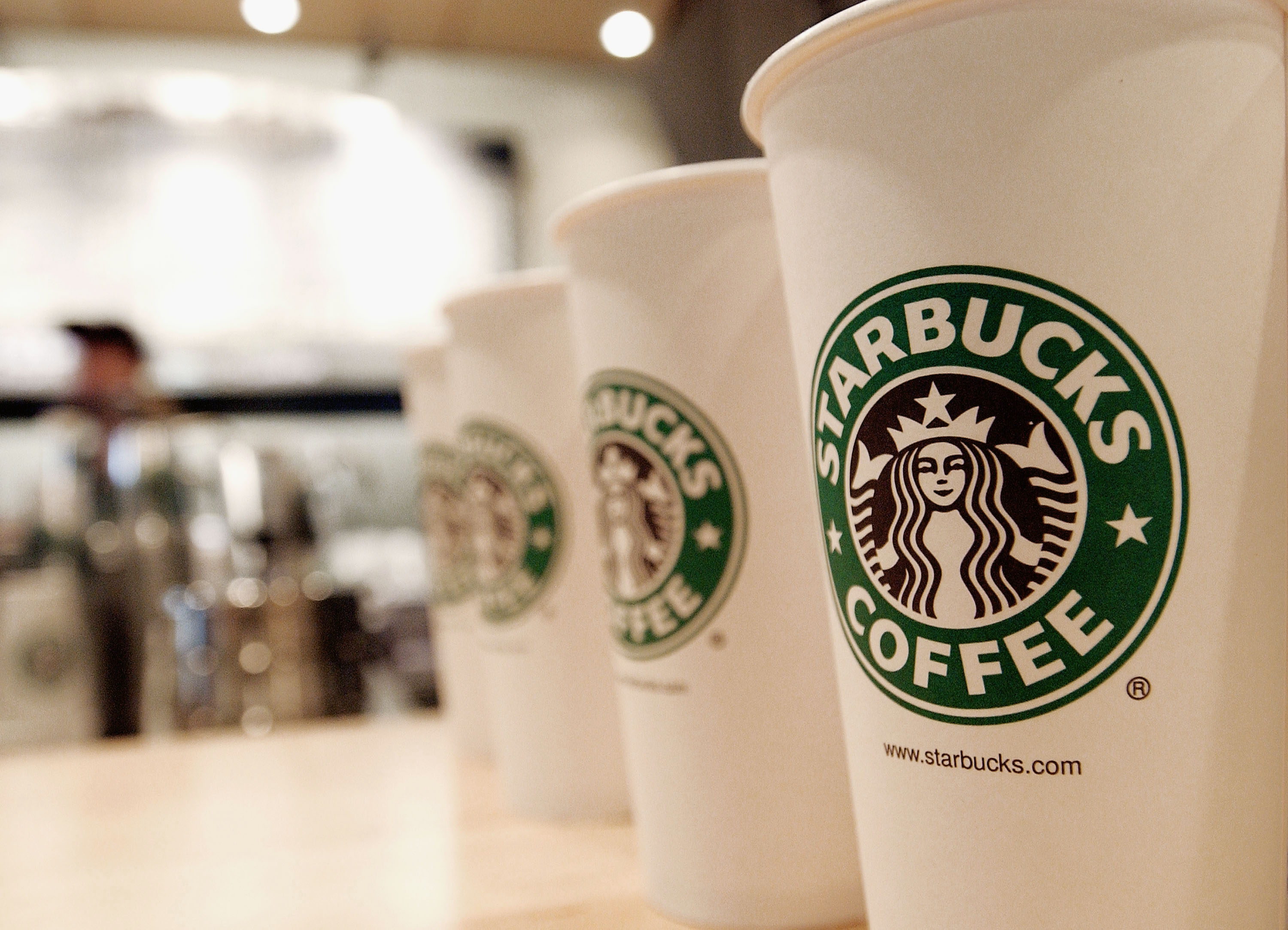 Beverage cups featuring the logo of Starbucks Coffee