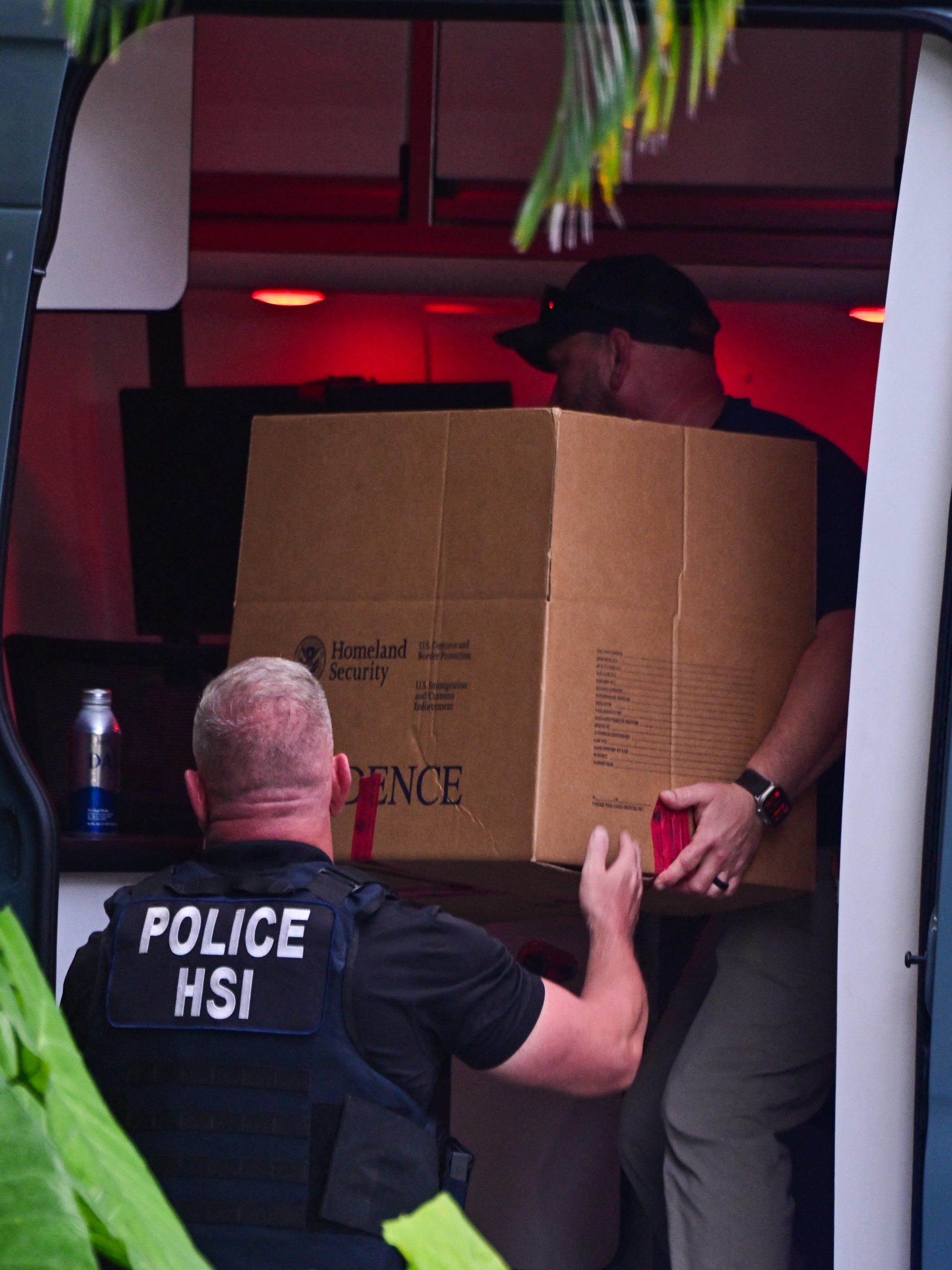 Homeland Security Investigation agents load a box into a car at the entrance of US producer and musician Sean "Diddy" Combs's home at Star Island in Miami Beach on March 25, 2024. Homes belonging to Sean "Diddy" Combs were being raided by federal agents, media reported on March 25, with the US hip hop mogul at the center of sex trafficking and sex assault lawsuits. (Photo by GIORGIO VIERA / AFP) (Photo by GIORGIO VIERA/AFP via Getty Images)