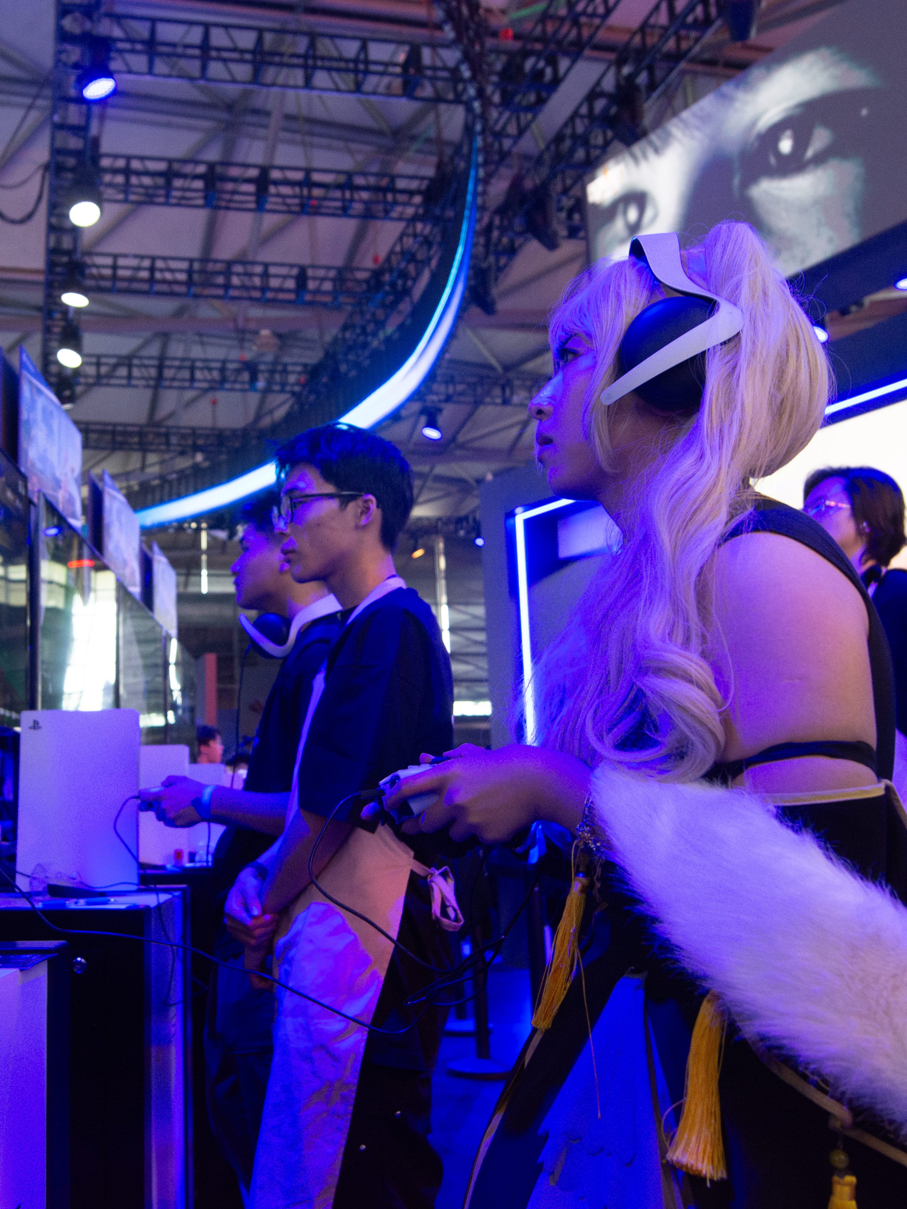 A cosplayer is playing games at the PlayStation game booth during the Chinajoy games fair in Shanghai, China, on July 26, 2024. (Photo by Ying Tang/NurPhoto via Getty Images)