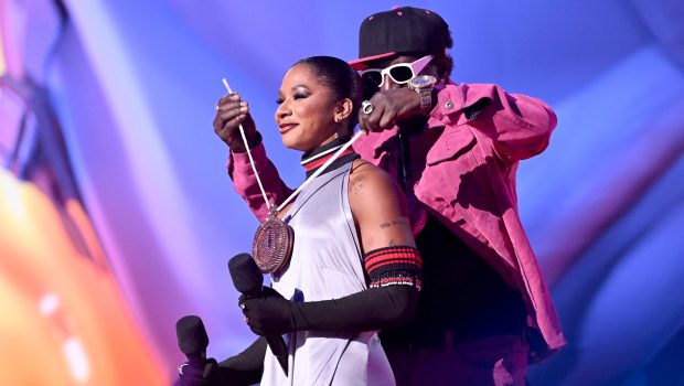 ELMONT, NEW YORK - SEPTEMBER 11: (L-R) Jordan Chiles and Flavor Flav speak on stage during the 2024 MTV Video Music Awards at UBS Arena on September 11, 2024 in Elmont, New York.  (Photo by Noam Galai/Getty Images for MTV)