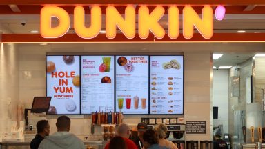 NEWARK, NJ - MAY 17: People line up at a Dunkin' store inside Terminal A at Newark Liberty International Airport on May 17, 2024, in Newark, New Jersey.  (Photo by Gary Hershorn/Getty Images)