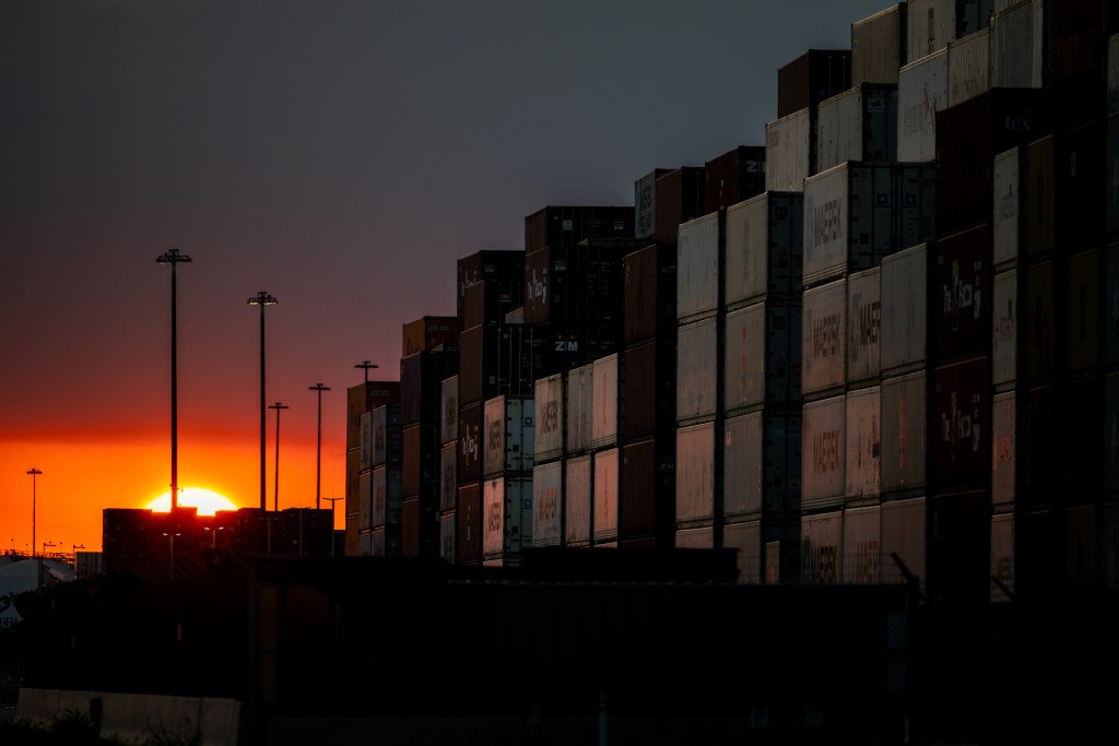 The sun sets behind shipping containers at the Port of Houston Authority on September 19, 2024 in Harris County, Texas. A potential strike by Port of Houston longshoremen looms as contract negotiations between the International Longshoreman's Association and the United States Maritime Alliance continue.  (Photo by Brandon Bell/Getty Images)