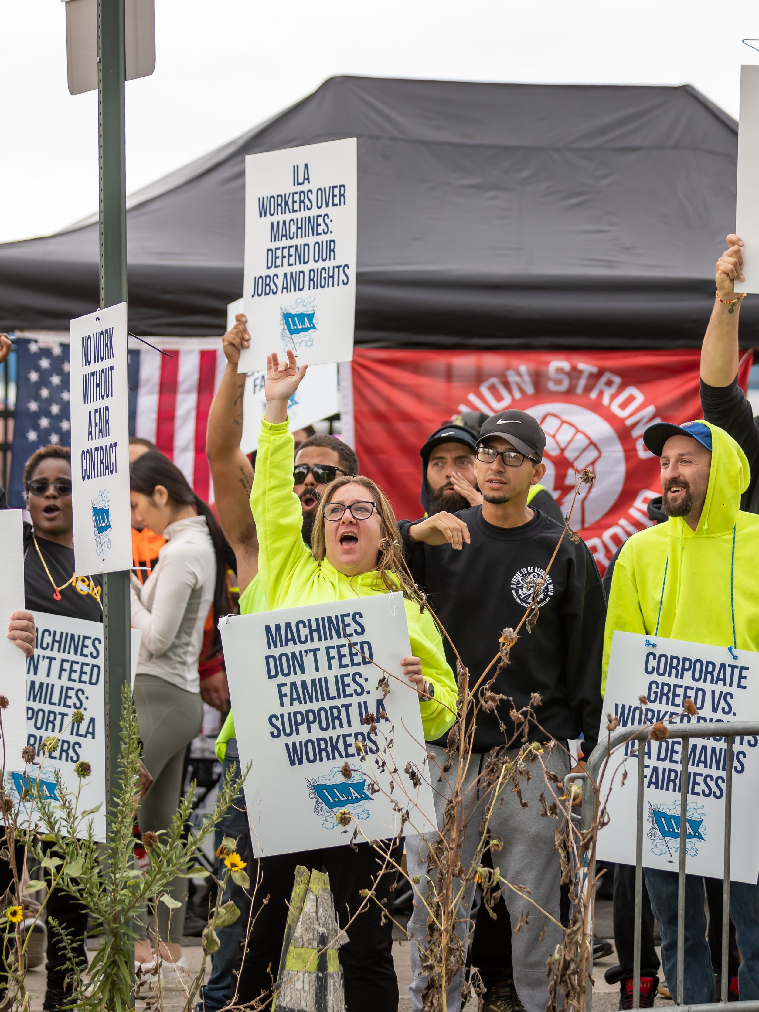 NEW YORK, UNITED STATES - 2024/10/01: Workers picket outside of the Red Hook Container Terminal in Brooklyn. Members of the International Longshoreman's Association walked out of every major port on the U.S. East and Gulf coasts after they failed to reach an agreement on better wages and automation with the United States Maritime Alliance. The strike is the first by the union since 1977 and could ripple across the world's largest economy causing political turmoil just weeks before the presidential election. (Photo by Michael Nigro/Pacific Press/LightRocket via Getty Images)