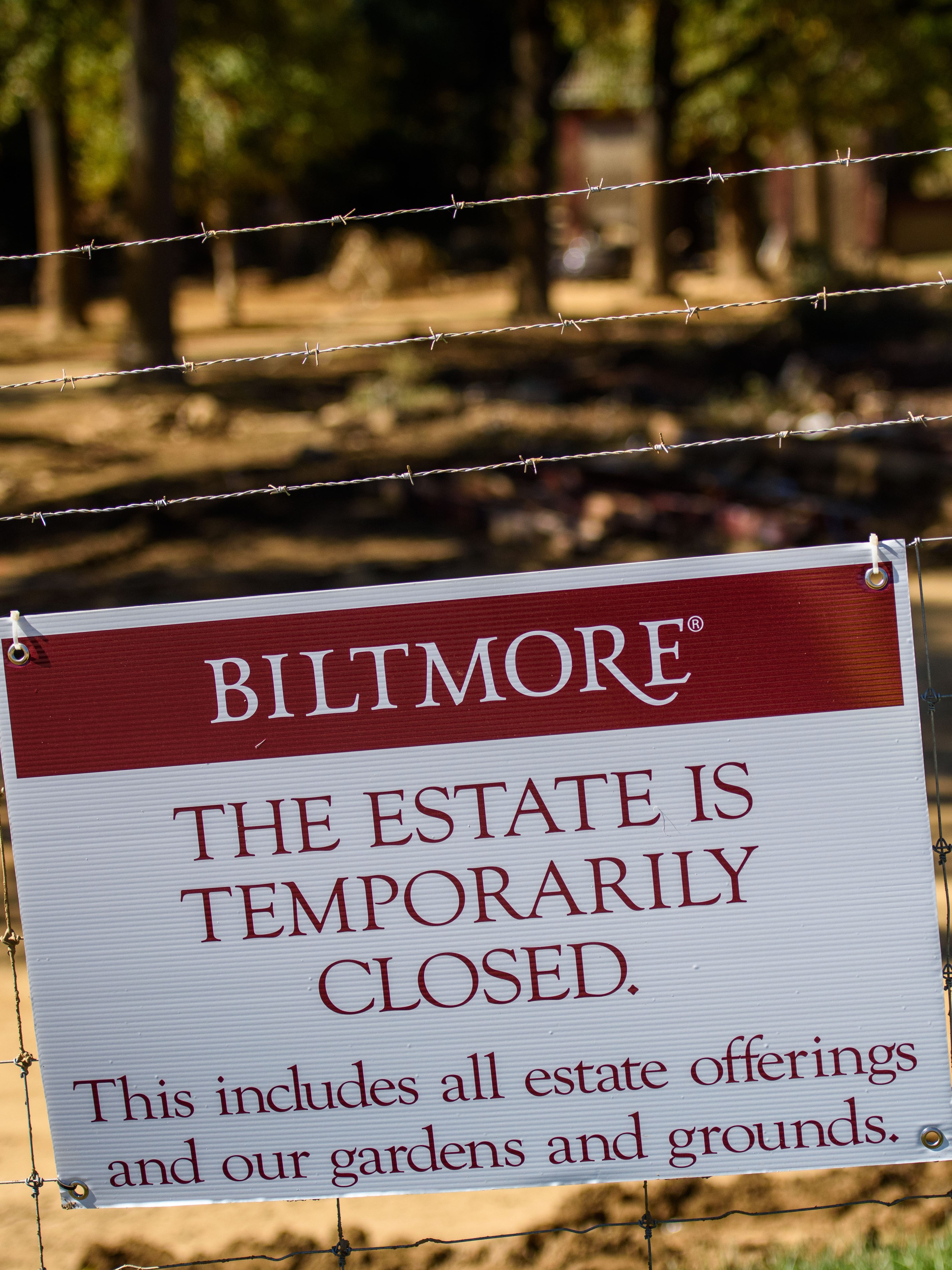 ASHEVILLE, NC - OCTOBER 9: A sign is posted outside the entrance of the Biltmore Estate in Asheville, NC on October 9, 2024. While the estate itself did not become damaged, its entrance and a popular shopping center across the street, Biltmore Village, sustained severe damage.