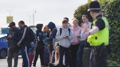 Passengers wait to enter Birmingham Airport after it was evacuated following a security alert. Picture date: Wednesday October 23, 2024. (Photo by Jacob King/PA Images via Getty Images)