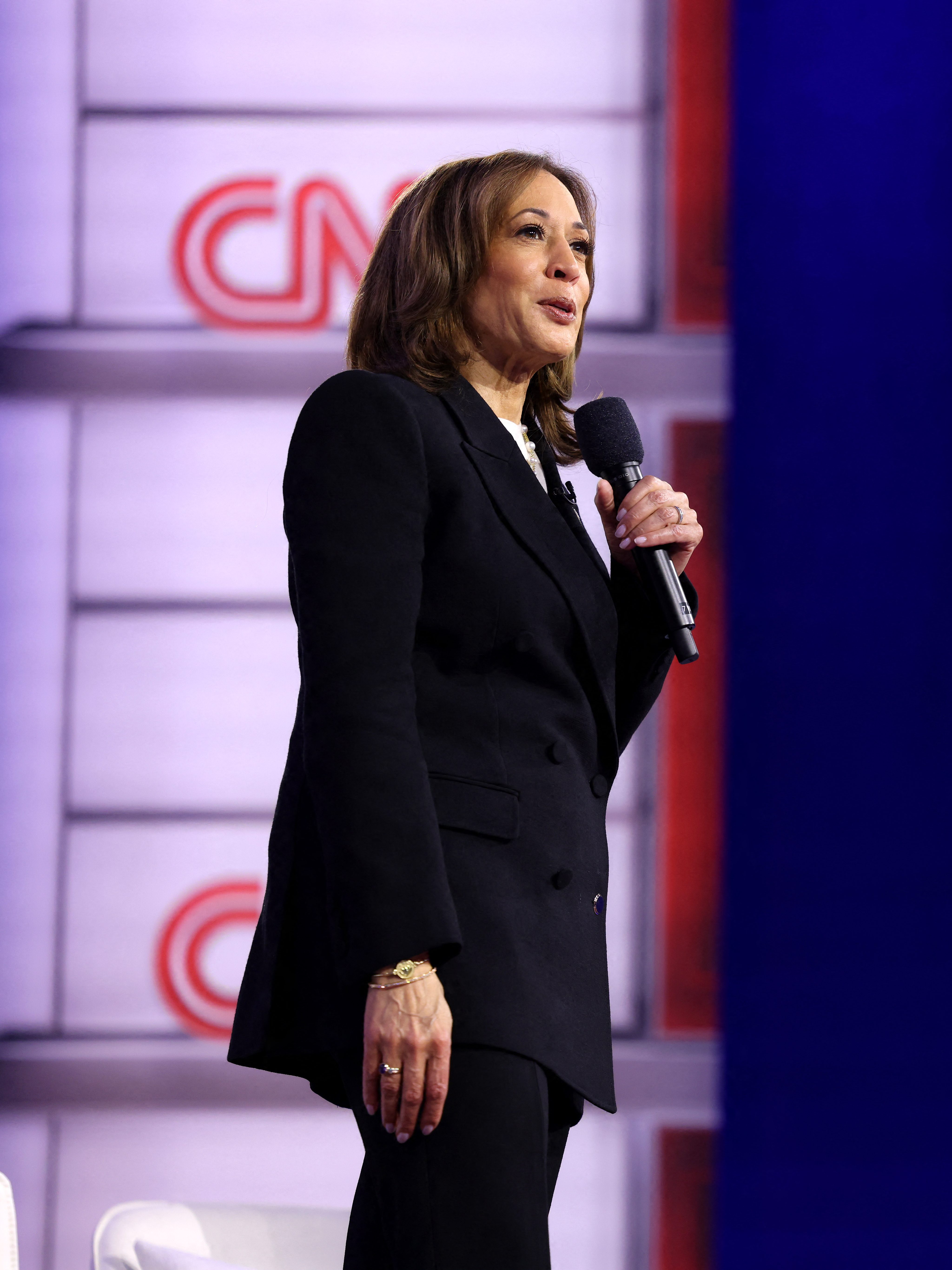 US Vice President and Democratic presidential candidate Kamala Harris speaks as she replies to a question from an attendee during a CNN Town Hall moderated by television host Anderson Cooper (R) at Sun Center studios in Aston, Pennsylvania, on October 23, 2024. (Photo by CHARLY TRIBALLEAU / AFP) (Photo by CHARLY TRIBALLEAU/AFP via Getty Images)