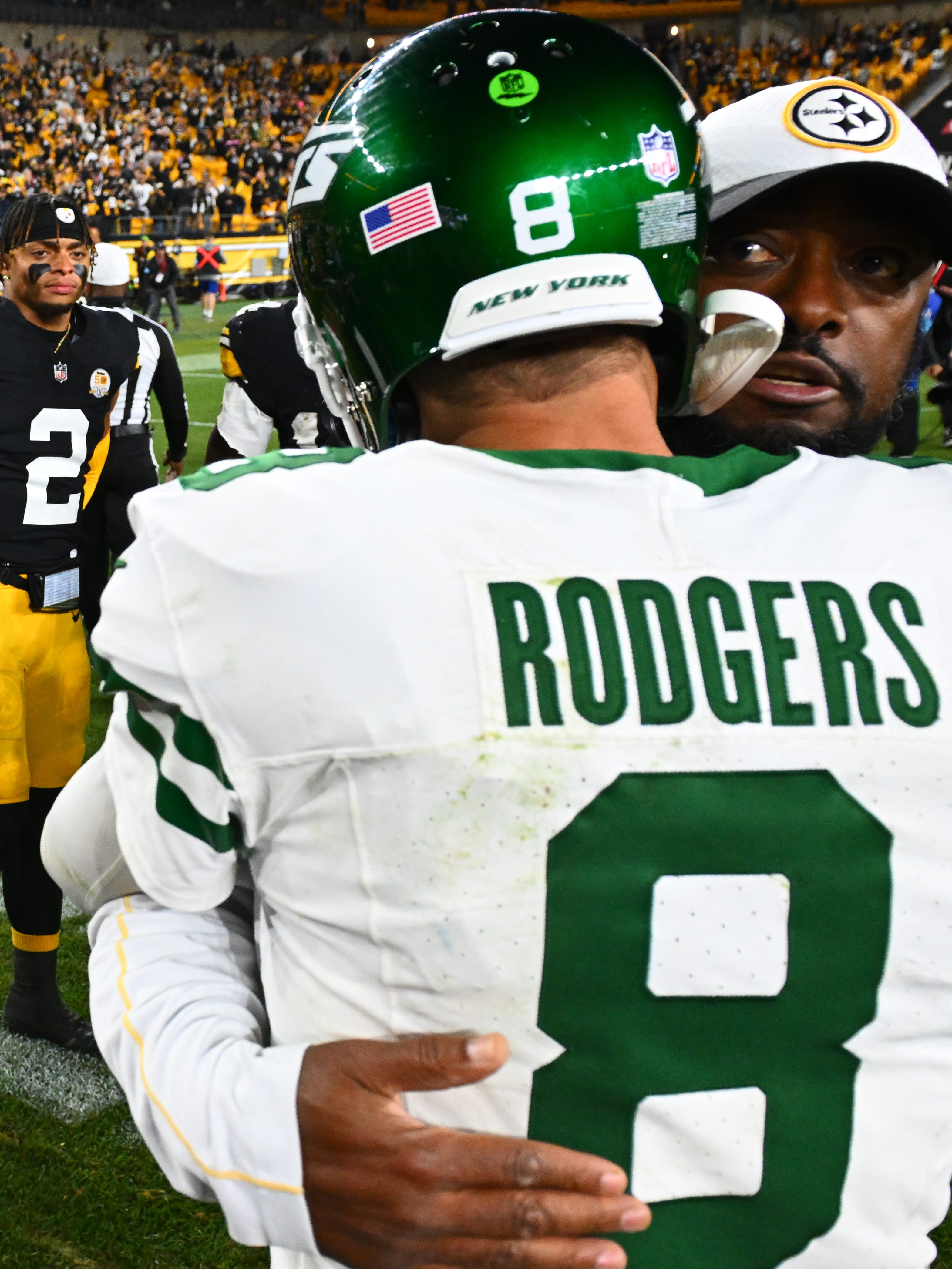PITTSBURGH, PENNSYLVANIA - OCTOBER 20: Russell Wilson #3 and Justin Fields #2 of the Pittsburgh Steelers look on as head coach Mike Tomlin of the Pittsburgh Steelers and Aaron Rodgers #8 of the New York Jets embrace after the game at Acrisure Stadium on October 20, 2024 in Pittsburgh, Pennsylvania. (Photo by Joe Sargent/Getty Images)