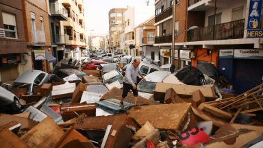 VALENCIA, SPAIN - OCTOBER 30: A man speaks on the phone beside a flooded street after flash floods hit the region on October 30, 2024 in the Sedaví area of Valencia, Spain. Spanish authorities said on Wednesday that at least 62 people had died in the Valencia region overnight after flash-flooding followed heavy rain. Spain's meteorological agency had issued its highest alert for the region due to extreme rainfall. (Photo by David Ramos/Getty Images)