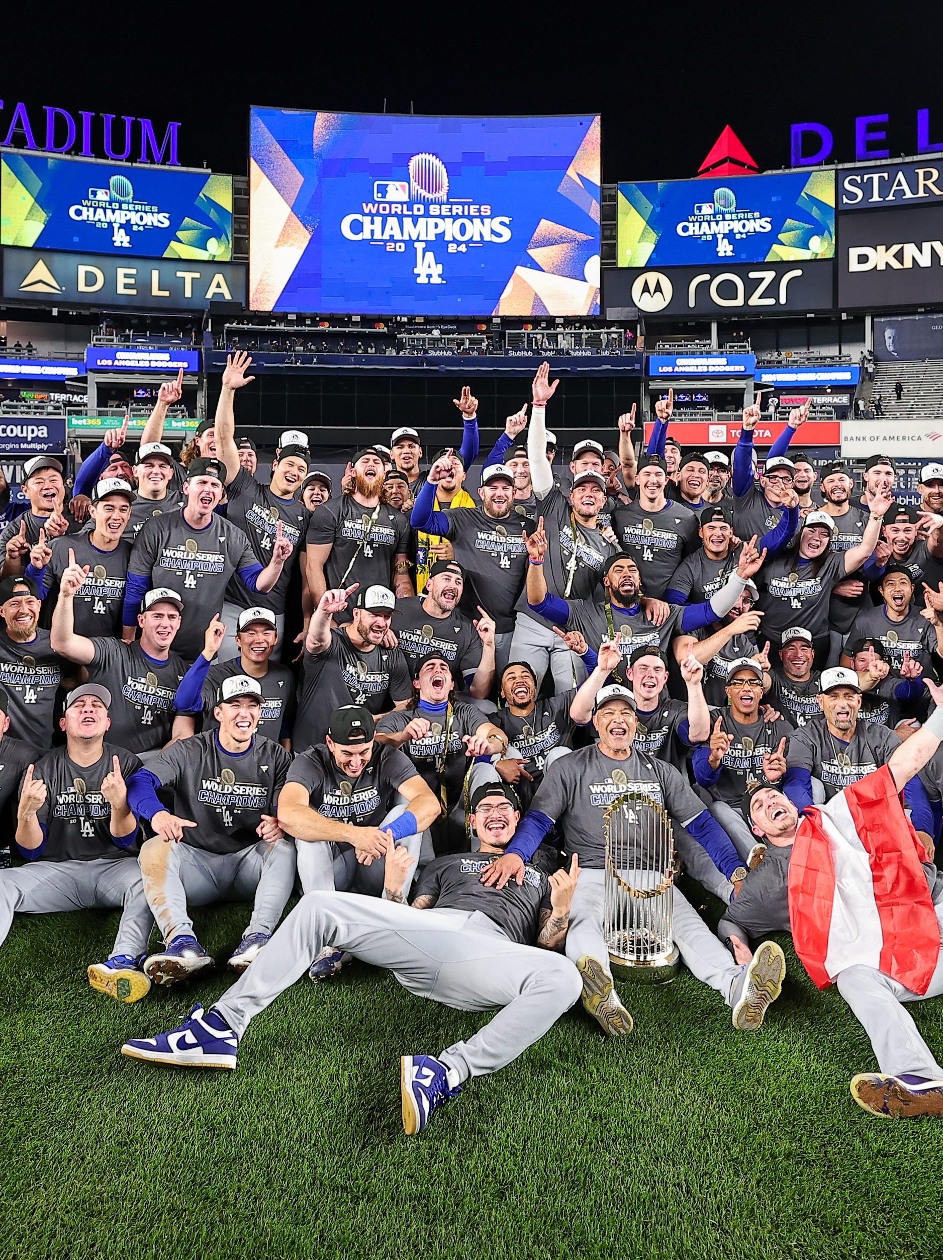 NEW YORK, NY - OCTOBER 30: Members of the Los Angeles Dodgers pose for a team photo on the field after defeating the New York Yankees in Game 5 of the 2024 World Series presented by Capital One between the Los Angeles Dodgers and the New York Yankees at Yankee Stadium on Wednesday, October 30, 2024 in New York, New York. (Photo by Dustin Satloff/MLB Photos via Getty Images)