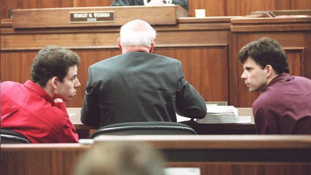 LOS ANGELES, UNITED STATES:  Erik (L) and Lyle (R) Menendez converse in the courtroom during a hearing in Los Angeles, in this 02 February 1995 file picture. They are accused of murdering their parents in 1989. (Photo credit should read KIM KULISH/AFP via Getty Images)