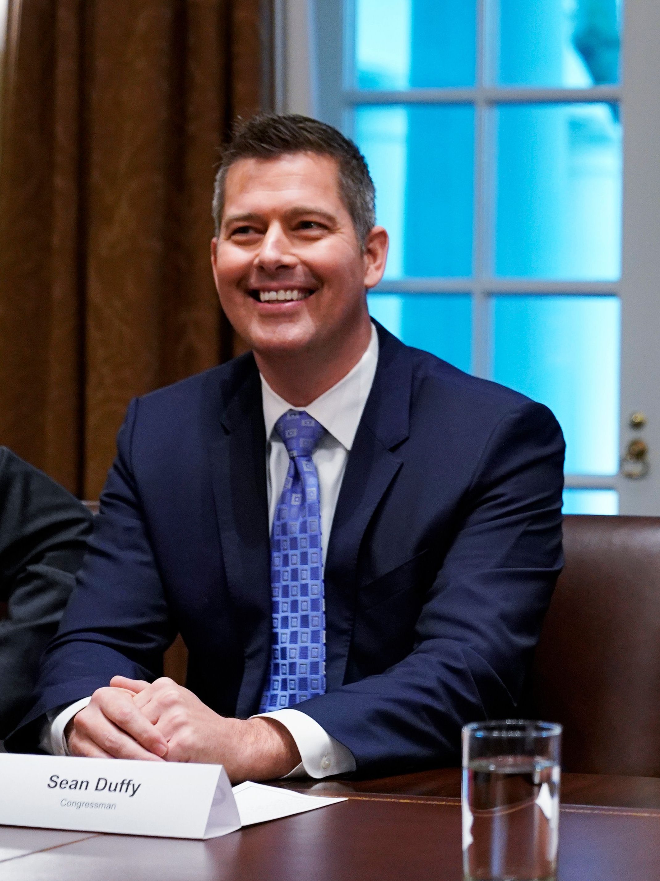 US President Donald Trump, with US Congressman Sean Duffy (L), holds a tariff table as he speaks in the Cabinet Room of the White House on January 24, 2019. - Trump spoke about the unfair trade practices at play in the world. (Photo by MANDEL NGAN / AFP)        (Photo credit should read MANDEL NGAN/AFP via Getty Images)