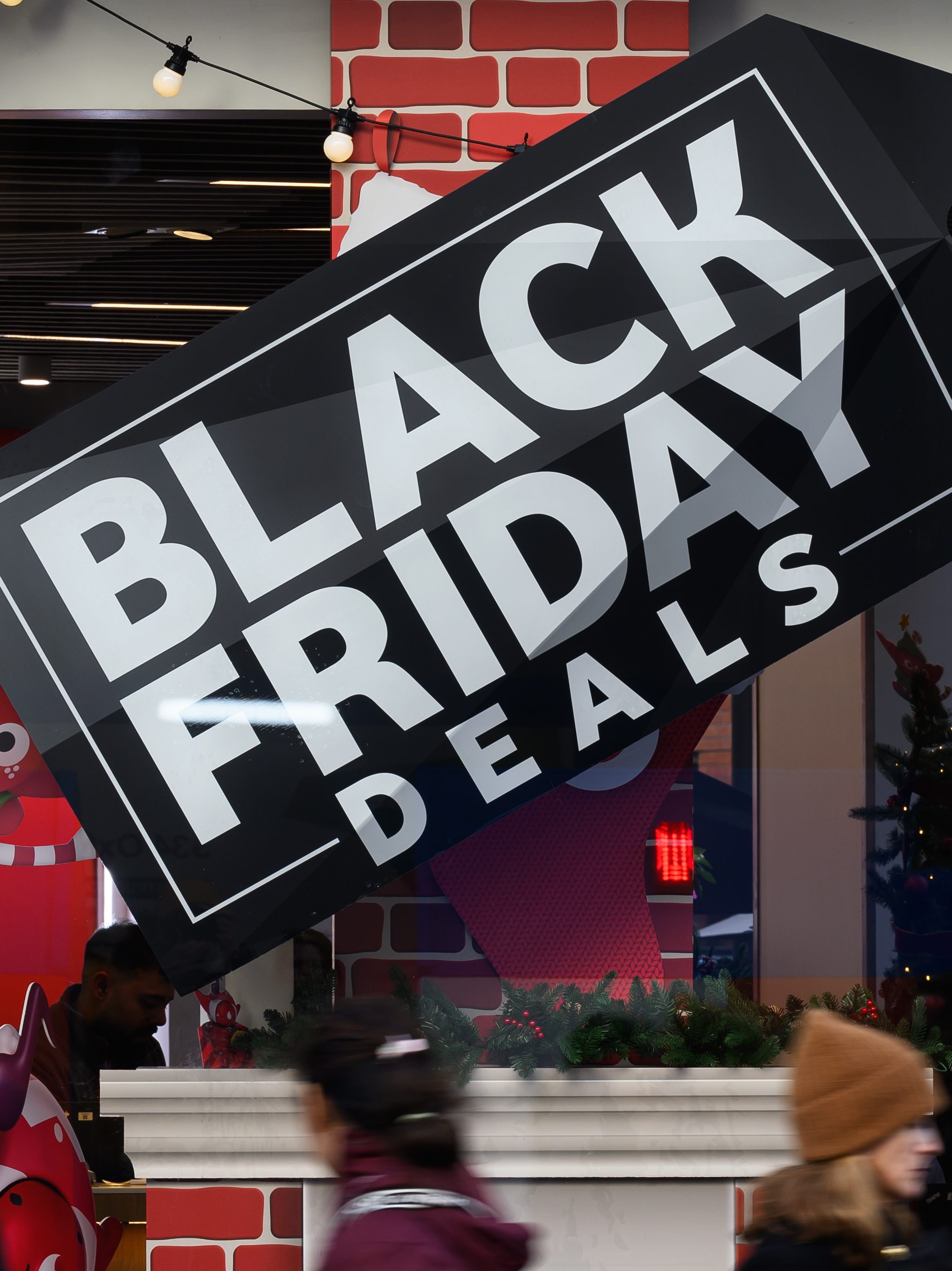 LONDON, ENGLAND - NOVEMBER 24: Signs advertising Black Friday sales are seen in the Oxford Street shopping district on November 24, 2023 in London, England. Traditionally Black Friday is the Friday after Thanksgiving in the United States where Christmas shopping is launched in the store with widespread discounted goods and sales.  In recent years this practice has been adopted by the UK retail trade. (Photo by Leon Neal/Getty Images)