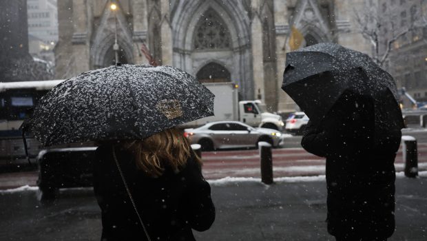 NEW YORK, NEW YORK - FEBRUARY 13: Snow is seen covering the umbrellas of people taking pictures at Rockefeller Center amid a winter storm on February 13, 2024 in New York City. The biggest winter storm in two years is hitting the Northeast with NYC forecasted to get three to five inches of snow. In anticipation of the storm, Mayor Eric Adams announced that schools would be going fully remote today. (Photo by Michael M. Santiago/Getty Images)