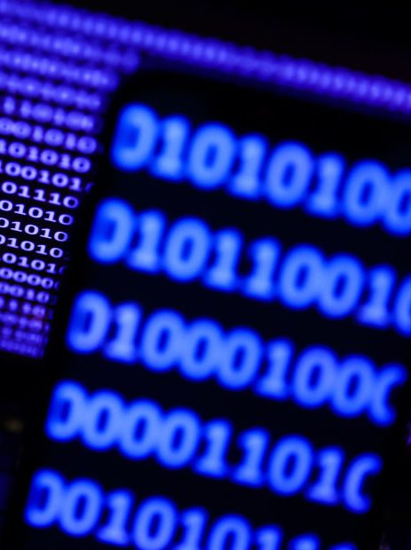 A binardy code displayed on a laptop screen and a binary code displayed on a phone screen are seen in this illustration photo taken in Krakow, Poland on October 30, 2023. (Photo by Jakub Porzycki/NurPhoto via Getty Images)