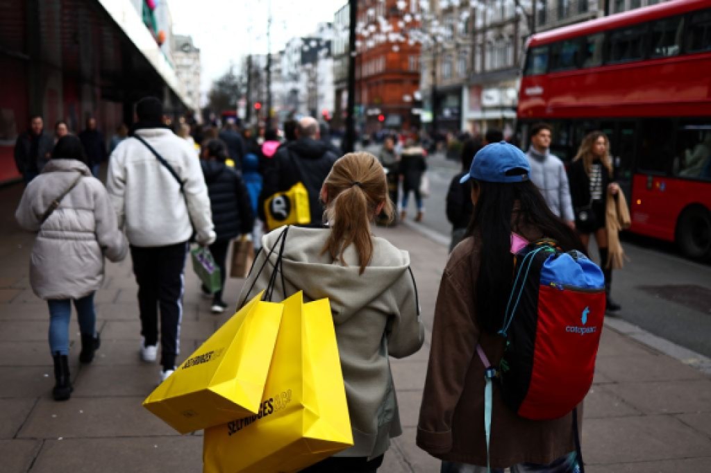 Shoppers carry their shopping bags along Oxford Street during the Boxing Day sales in London on December 26, 2023. (Photo by HENRY NICHOLLS / AFP) (Photo by HENRY NICHOLLS/AFP via Getty Images)