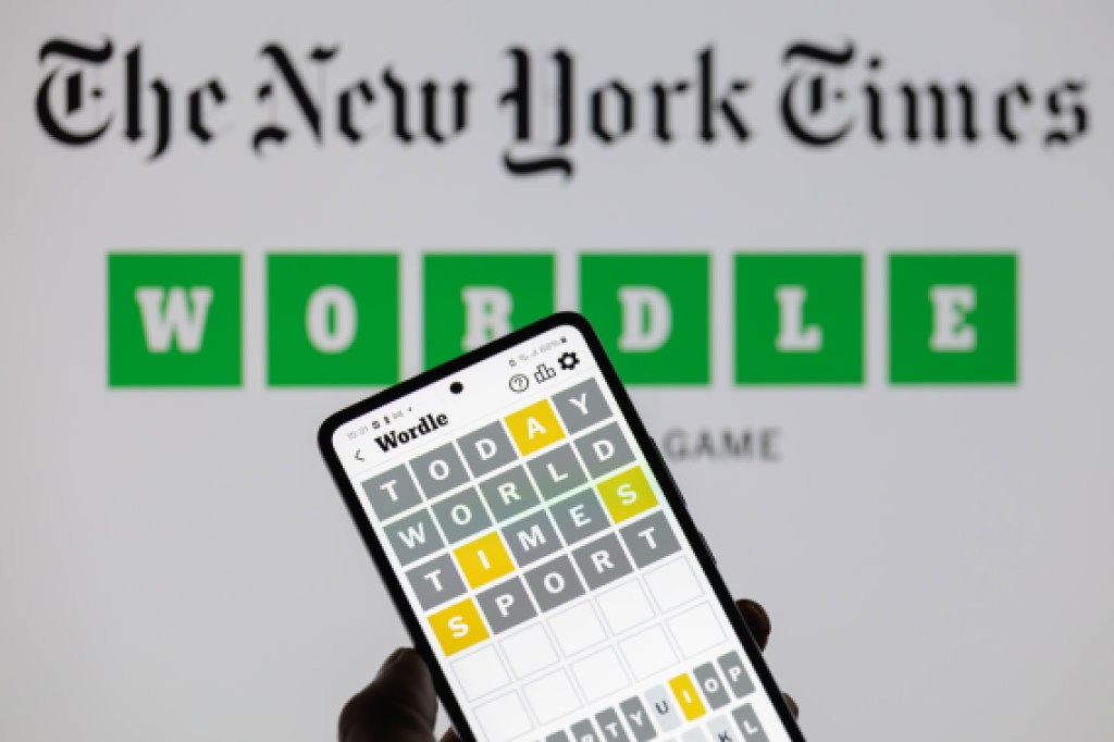 The Wordle app is being displayed on a smartphone with The New York Times visible in the background in this photo illustration in Brussels, Belgium, on June 1, 2024. (Photo by Jonathan Raa/NurPhoto via Getty Images)