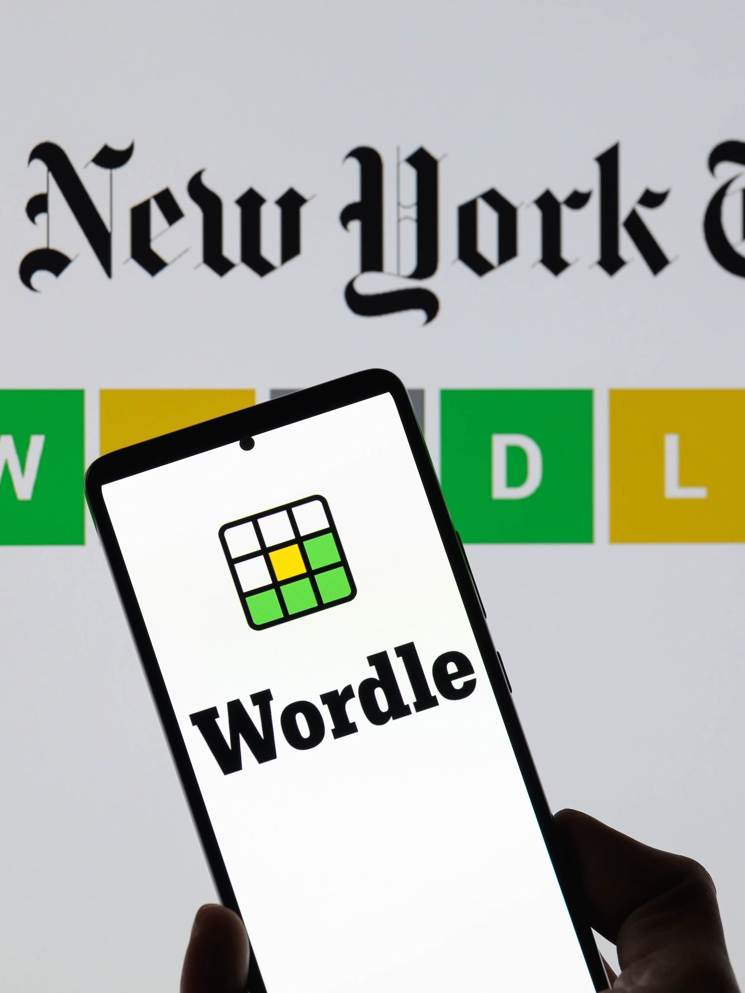 The Wordle logo is being displayed on a smartphone with The New York Times visible in the background in this photo illustration in Brussels, Belgium, on June 1, 2024. (Photo by Jonathan Raa/NurPhoto)