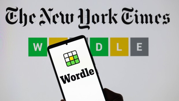 The Wordle logo is being displayed on a smartphone with The New York Times visible in the background in this photo illustration in Brussels, Belgium, on June 1, 2024. (Photo by Jonathan Raa/NurPhoto)