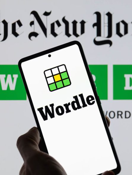 The Wordle logo is being displayed on a smartphone with The New York Times visible in the background in this photo illustration in Brussels, Belgium, on June 1, 2024. (Photo by Jonathan Raa/NurPhoto via Getty Images)
