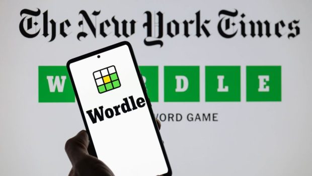 The Wordle logo is being displayed on a smartphone with The New York Times visible in the background in this photo illustration in Brussels, Belgium, on June 1, 2024. (Photo by Jonathan Raa/NurPhoto via Getty Images)