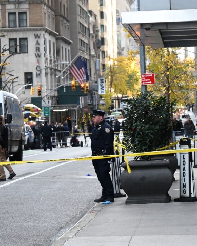 MANHATTAN, NEW YORK, UNITED STATES - DECEMBER 4: Police officers take security measures as CEO of UnitedHealthcare Brian Thompson shot and killed in Midtown Manhattan, New York, United States on December 4, 2024. The CEO of UnitedHealthcare was killed in a Midtown shooting near a hotel on 54th Street between 6th and 7th Avenues. He was rushed to an area hospital and later died. (Photo by Kyle Mazza/Anadolu via Getty Images)