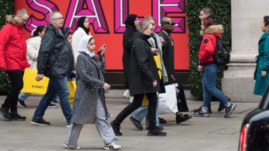 LONDON, UNITED KINGDOM - DECEMBER 26: Shoppers walk outside Selfridge's store in Oxford Street during Boxing Day sales in London, United Kingdom on December 26, 2024. The second day of Christmas holidays, Boxing Day sees retailers offer large discounts which attract customers who this year are predicted to spend £3.73billion on the day itself on the high street and online. (Photo by Wiktor Szymanowicz/Anadolu via Getty Images)