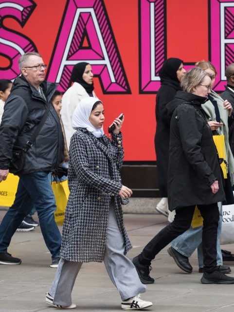 LONDON, UNITED KINGDOM - DECEMBER 26: Shoppers walk outside Selfridge's store in Oxford Street during Boxing Day sales in London, United Kingdom on December 26, 2024. The second day of Christmas holidays, Boxing Day sees retailers offer large discounts which attract customers who this year are predicted to spend £3.73billion on the day itself on the high street and online. (Photo by Wiktor Szymanowicz/Anadolu via Getty Images)