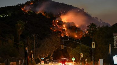 LOS ANGELES, CALIFORNIA - JANUARY 9: A view of flames at the mountain as seen from Topanga Canyon near Pacific Palisades in Topanga, Los Angeles, California, United States on January 9, 2025. A fast-moving wildfire has forced 180,000 people to evacuate, with officials warning that worsening winds could further escalate the blaze. (Photo by Tayfun Coskun/Anadolu via Getty Images)